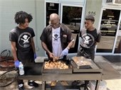 Teens participating in the A Seat At The Table program learning from Chef Jack