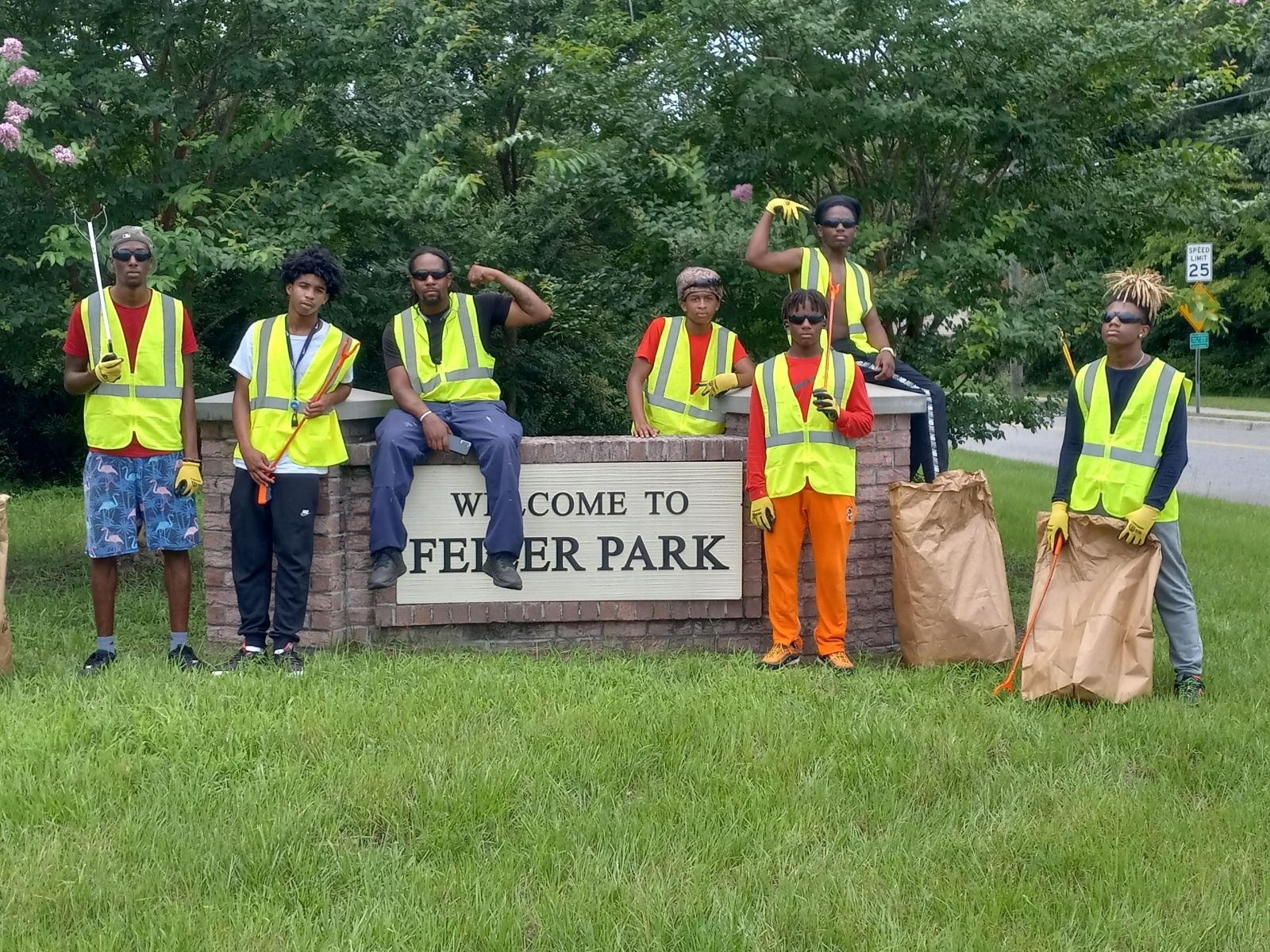 Feiler Park Neighborhood Improvement Team 2022 poses with their neighborhood sign